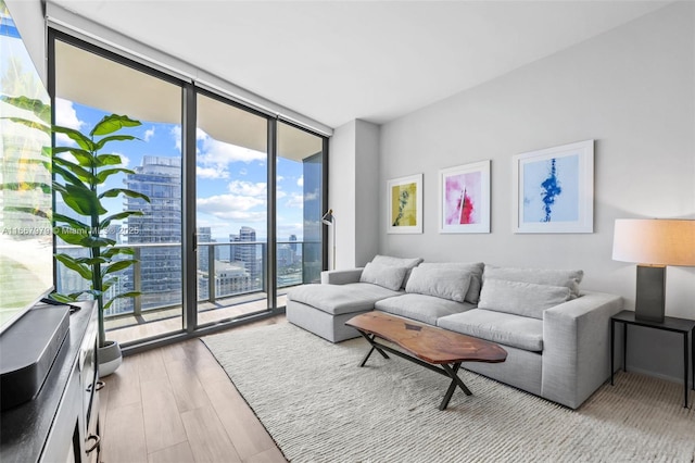 living room featuring floor to ceiling windows and light hardwood / wood-style floors