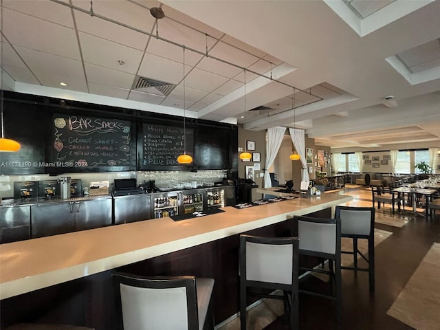 bar featuring dark hardwood / wood-style floors and hanging light fixtures