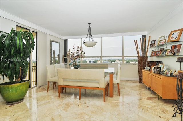 dining space featuring crown molding