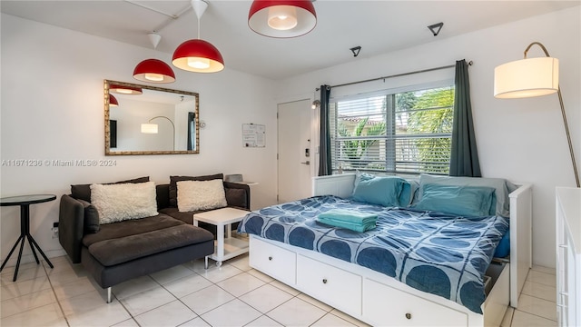 bedroom with tile patterned floors and rail lighting