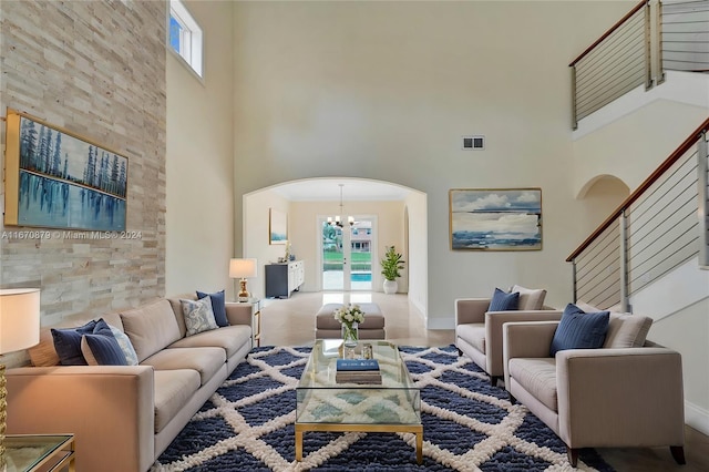 living room featuring a high ceiling and a chandelier