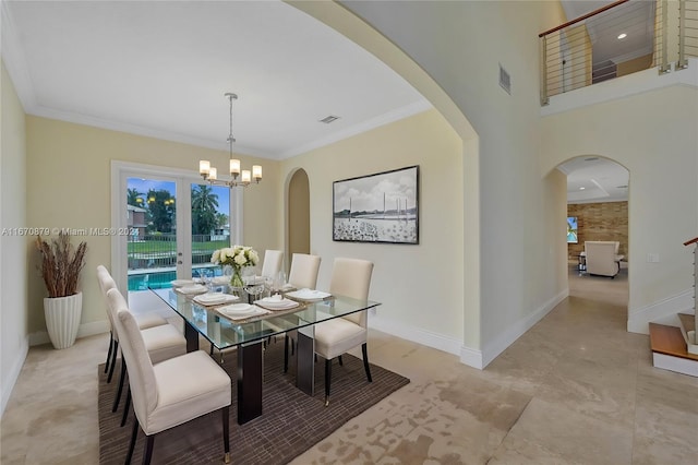 dining room featuring an inviting chandelier, french doors, and crown molding