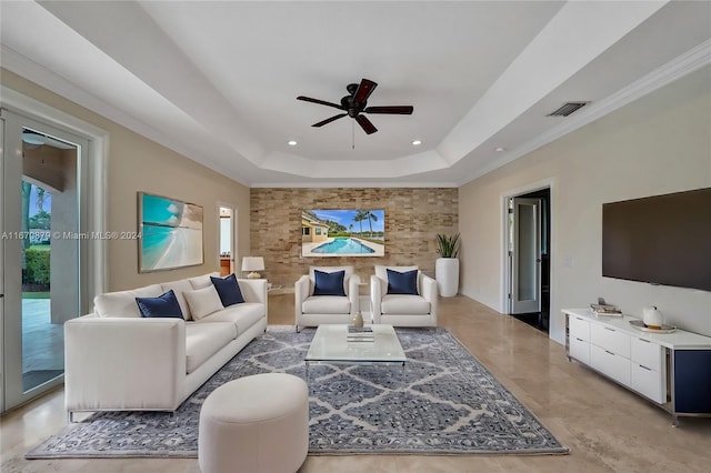 living room with crown molding, ceiling fan, and a raised ceiling