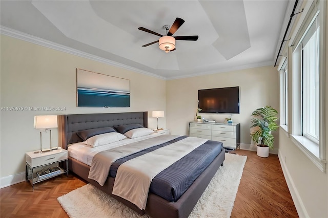 bedroom featuring a raised ceiling, ceiling fan, and crown molding