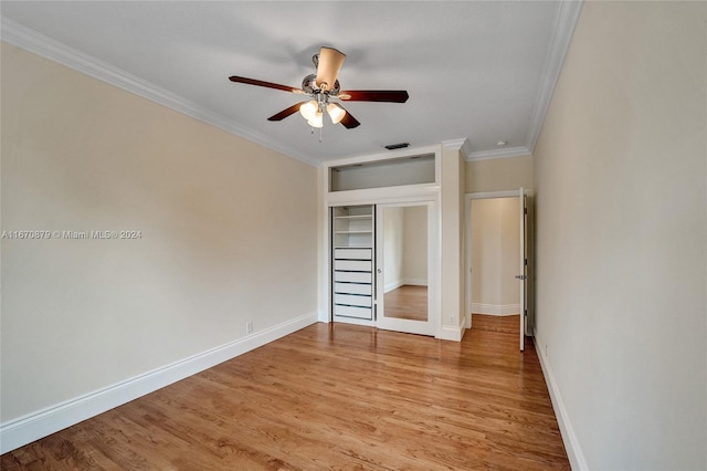 unfurnished bedroom with a closet, crown molding, ceiling fan, and light hardwood / wood-style flooring