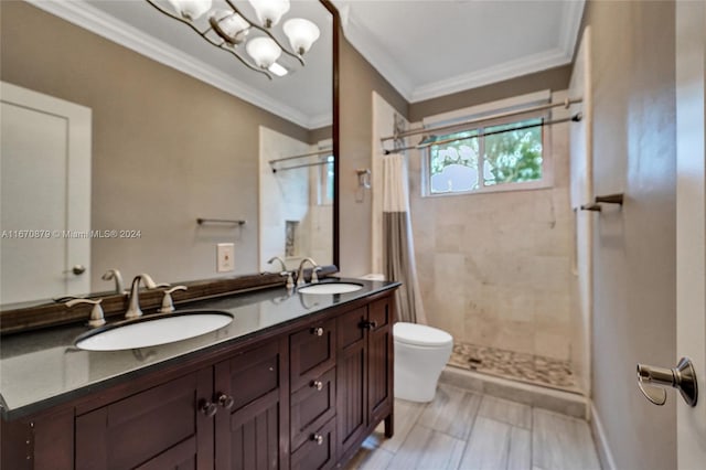 bathroom featuring a shower with shower curtain, vanity, toilet, and crown molding