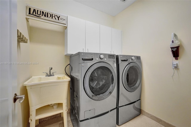 laundry area with cabinets and washing machine and clothes dryer