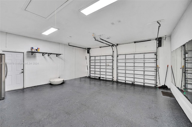 garage with stainless steel refrigerator