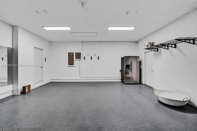 garage featuring electric panel and stainless steel fridge with ice dispenser