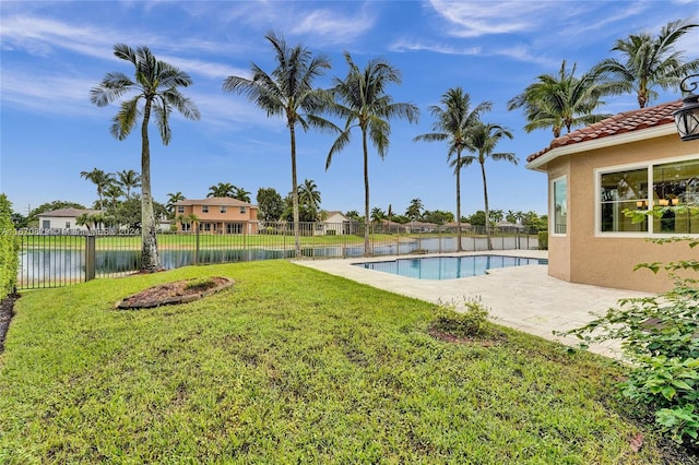 view of yard featuring a fenced in pool, a patio area, and a water view