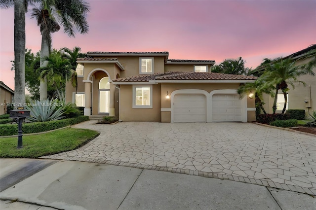 mediterranean / spanish-style house featuring a garage