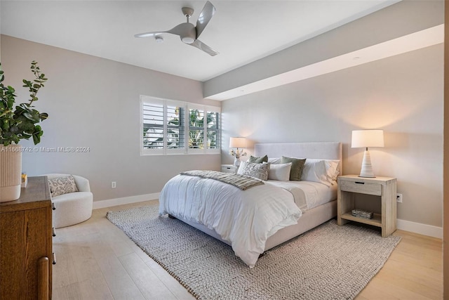 bedroom featuring light wood-type flooring and ceiling fan