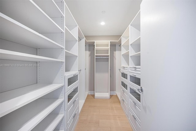 walk in closet featuring light hardwood / wood-style flooring