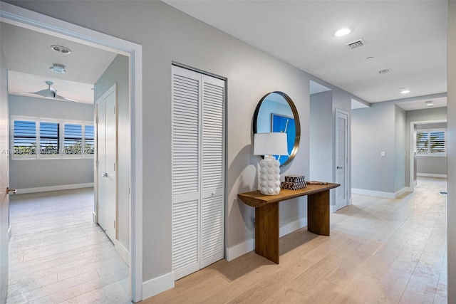 hallway featuring light hardwood / wood-style floors and a wealth of natural light