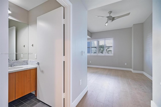 bathroom with ceiling fan, vanity, and hardwood / wood-style flooring