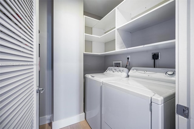 laundry area featuring light hardwood / wood-style floors and washer and dryer