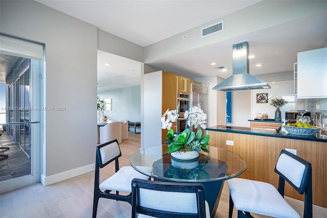 dining space with light hardwood / wood-style flooring