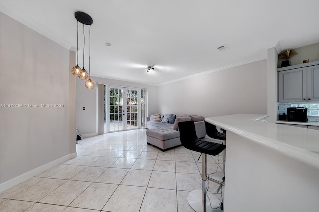 tiled living room with crown molding and french doors