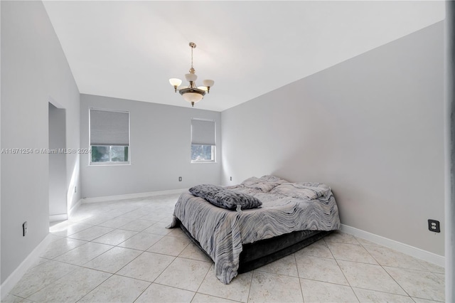 tiled bedroom featuring an inviting chandelier