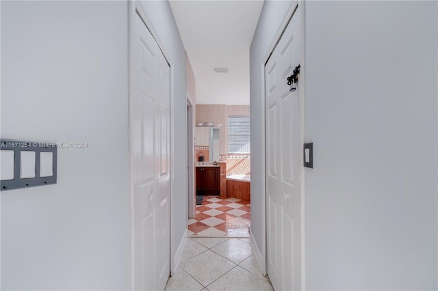 hallway featuring light tile patterned flooring