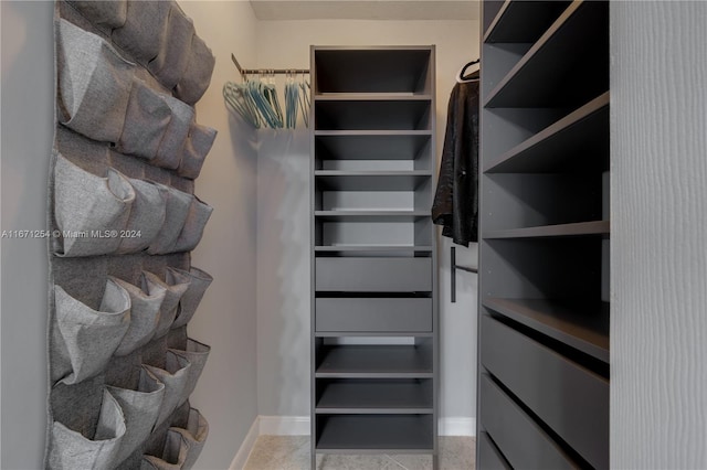 spacious closet featuring light tile patterned flooring