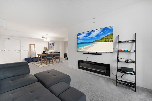 carpeted living room featuring a chandelier