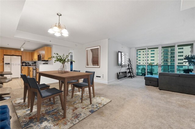 dining room with a notable chandelier and light colored carpet