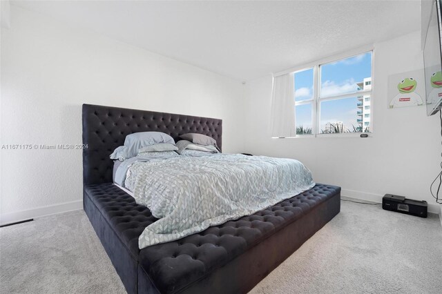 bedroom featuring a textured ceiling and carpet floors