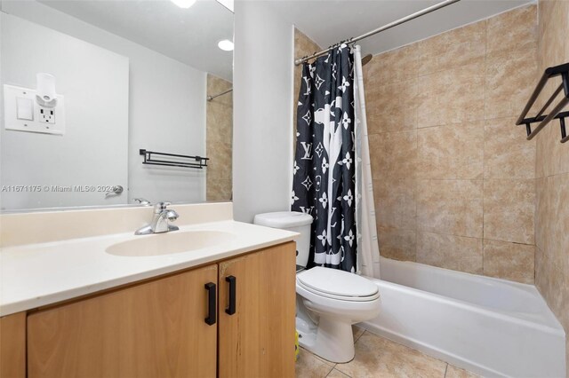 full bathroom featuring vanity, tile patterned floors, toilet, and shower / bath combo