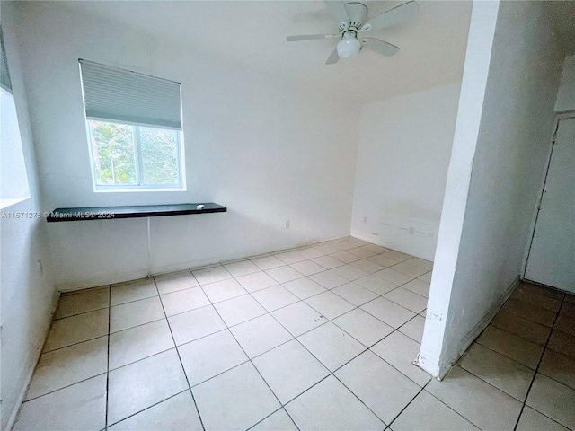 tiled empty room with ceiling fan