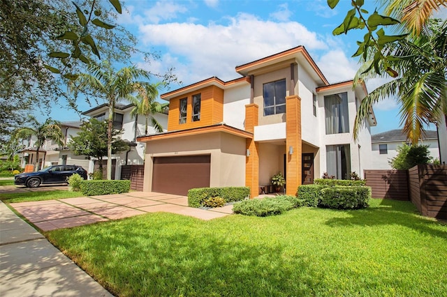 view of front of home with a garage and a front yard