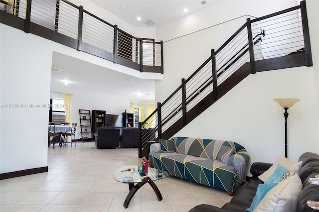 living room featuring a high ceiling and light tile patterned floors