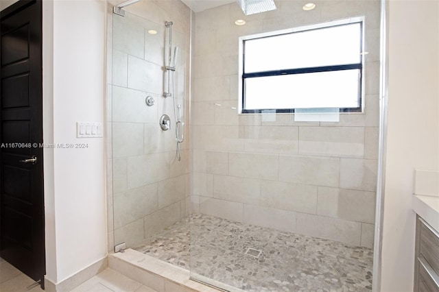 bathroom featuring walk in shower, vanity, and tile patterned floors