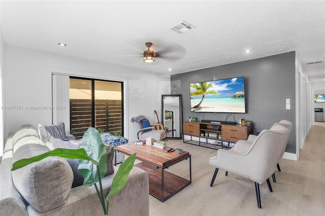 living room with light hardwood / wood-style flooring and ceiling fan