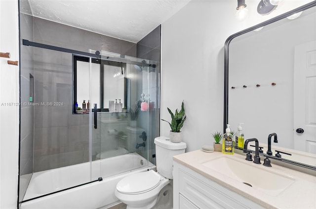 full bathroom with a textured ceiling, bath / shower combo with glass door, vanity, and toilet