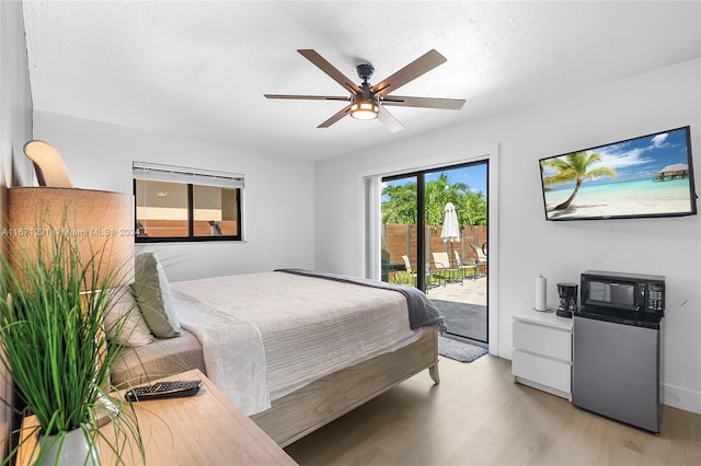 bedroom with light hardwood / wood-style flooring, ceiling fan, and access to exterior