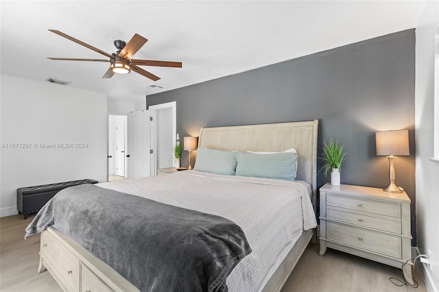 bedroom with ceiling fan and light wood-type flooring