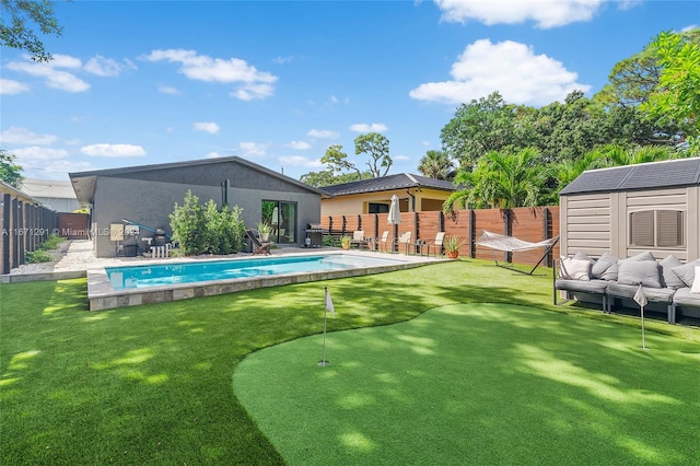 view of swimming pool with a storage shed, an outdoor living space, and a patio area