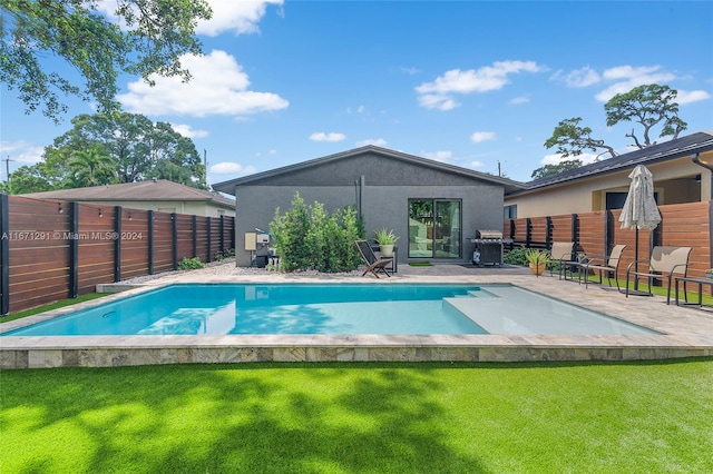 view of pool with a lawn and a patio area