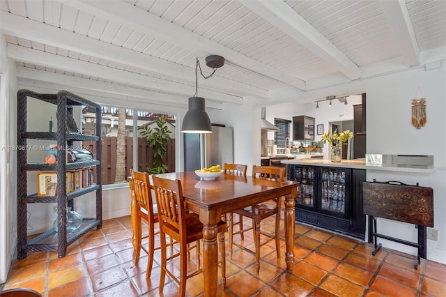 dining area with wooden ceiling and beamed ceiling