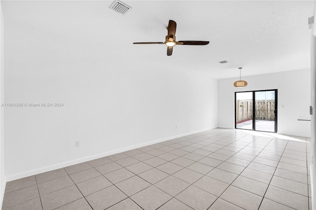 unfurnished room with ceiling fan and light tile patterned flooring