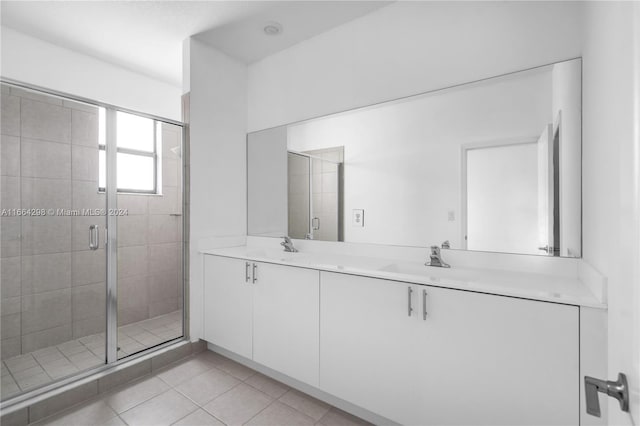 bathroom featuring walk in shower, vanity, and tile patterned floors