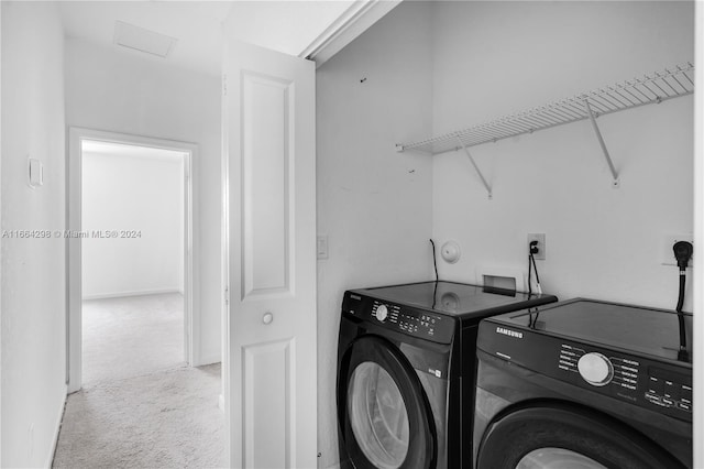 laundry room with carpet floors and independent washer and dryer