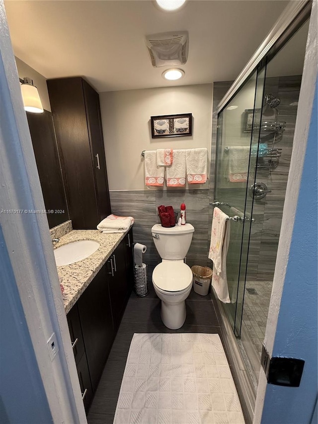 bathroom featuring walk in shower, vanity, and toilet