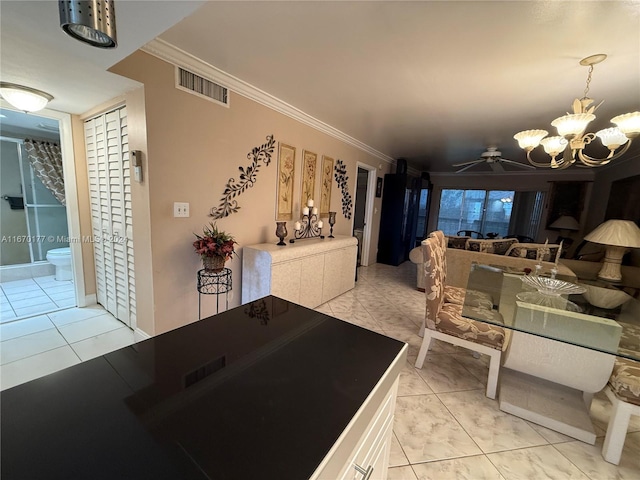 tiled dining area with ceiling fan with notable chandelier and crown molding