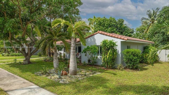 view of side of home with a yard