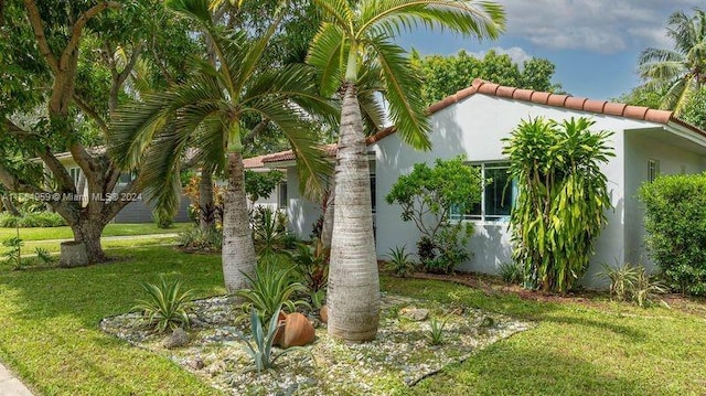 view of side of property with a yard