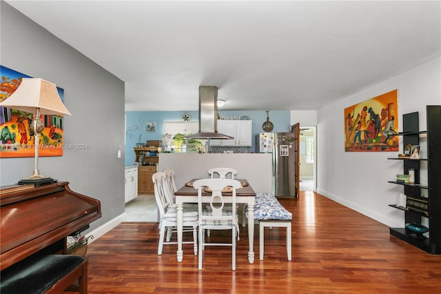 dining space with hardwood / wood-style flooring