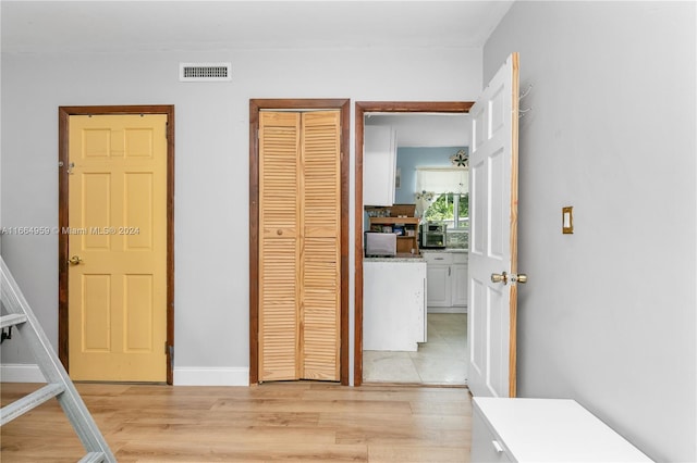 unfurnished bedroom with a closet and light hardwood / wood-style floors