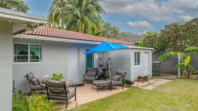 rear view of property with a patio and a yard